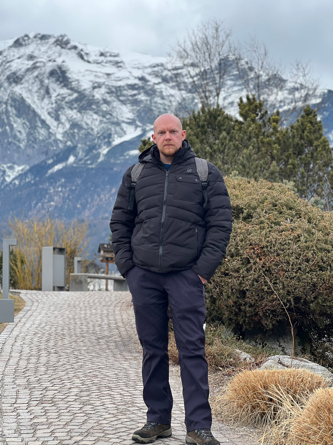 HikeWare founder standing in front of the Austrian mountains wearing hiking gear
