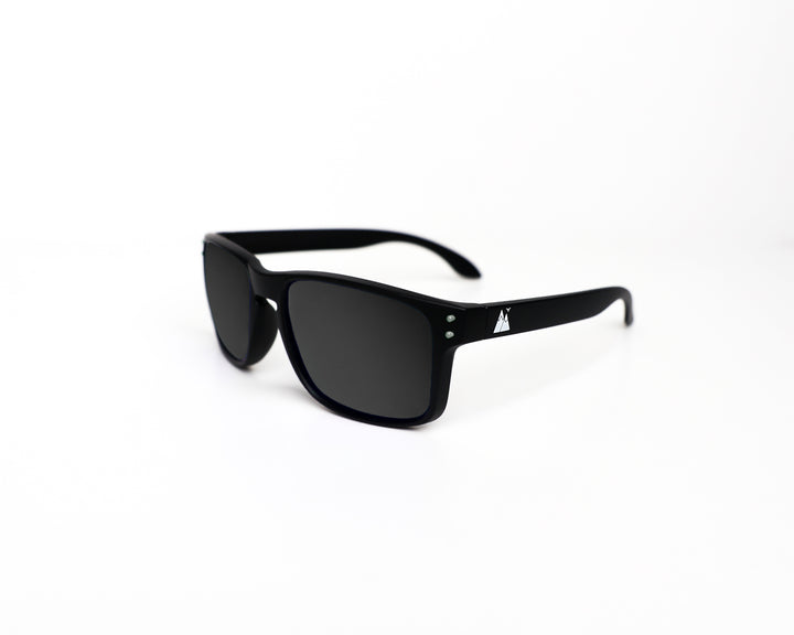 Black Night Cat polarised sunglasses with a sleek matte finish, featuring a subtle mountain logo on the temple and dark tinted lenses, displayed against a clean white background.