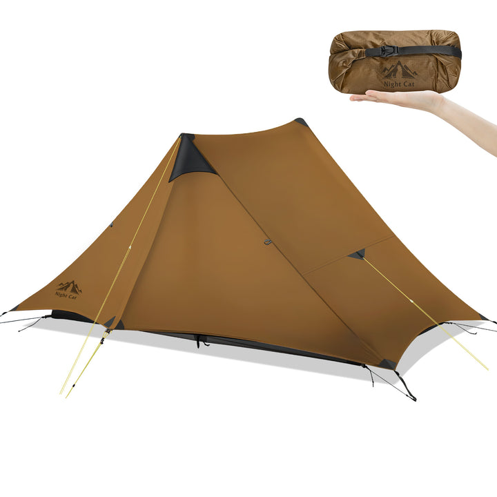 A brown lightweight Night Cat camping tent shown assembled on a white background, with a hand holding its matching brown rolled carrying bag in the upper right. The tent has black trim and visible tenting poles. 