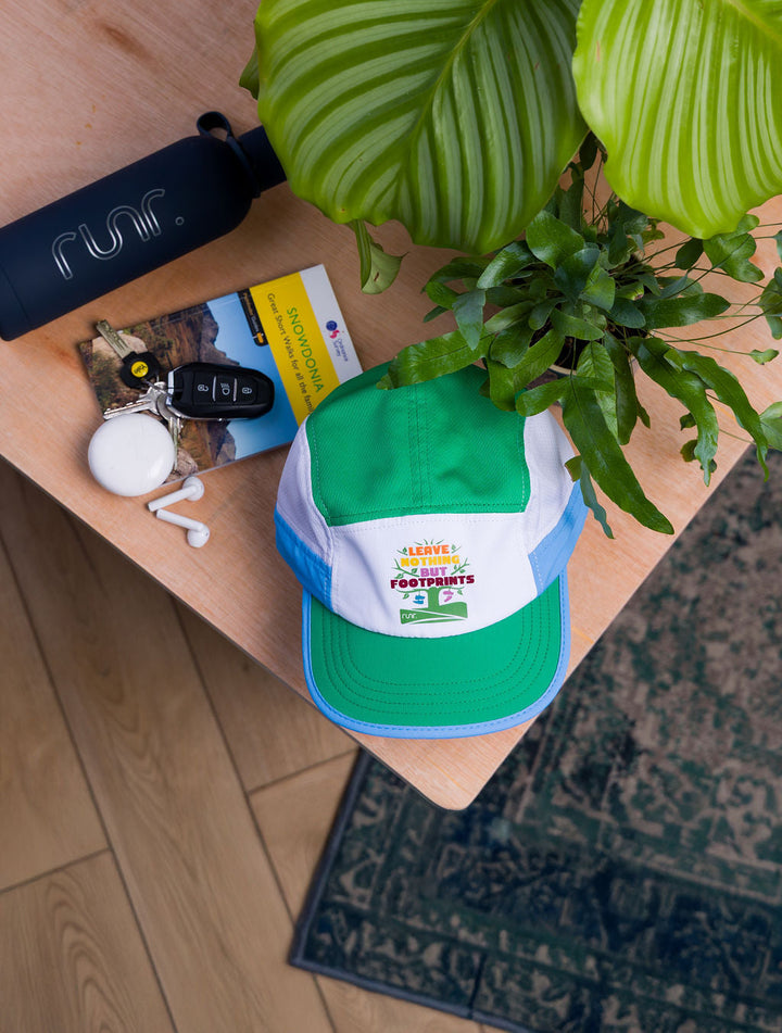 Trail runner wearing the Runr Leave Nothing But Footprints Trails hat