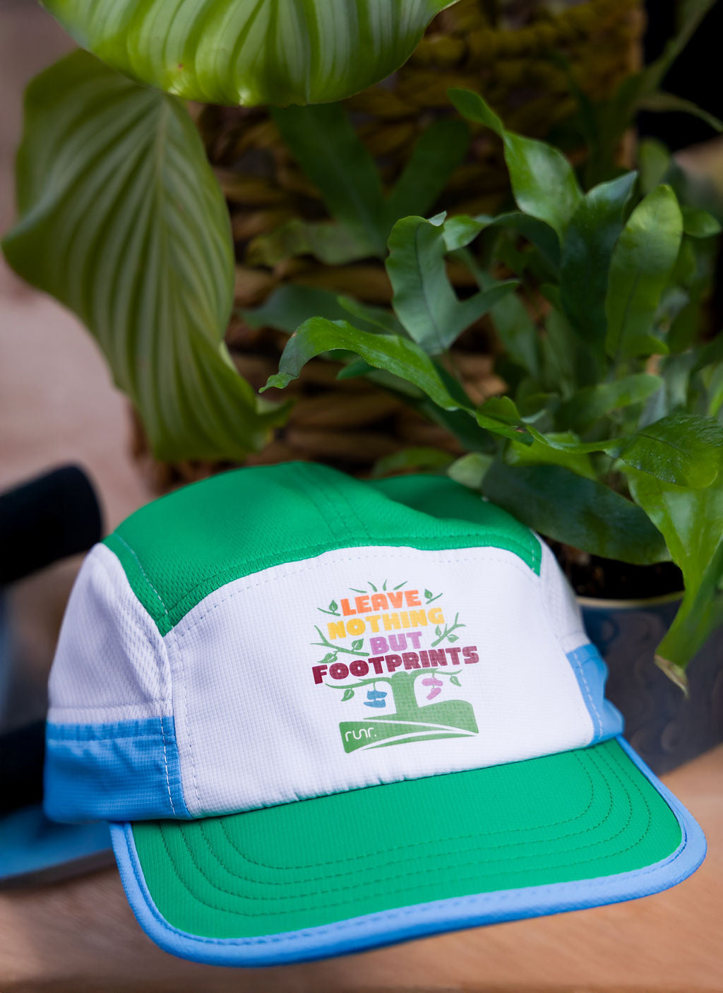 Runr Leave Nothing But Footprints Trails hat worn on a run