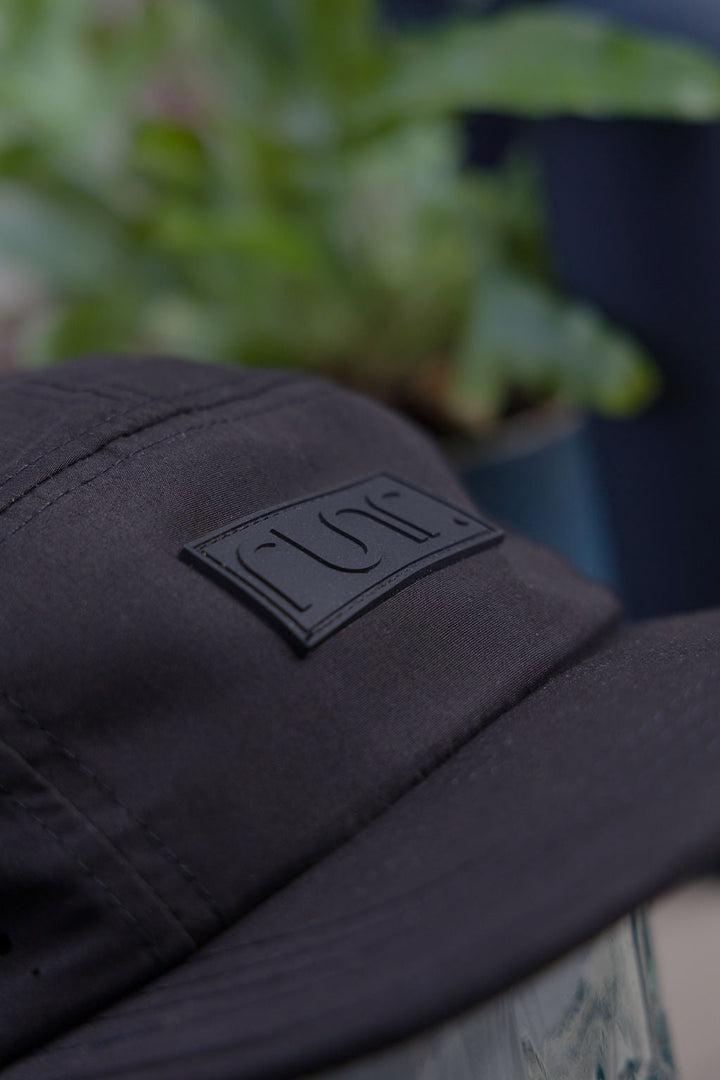 Runr Milan Blackout running hat worn on a run