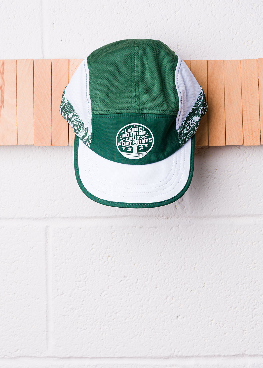 Runr Leave Nothing But Footprints running hat worn outdoors
