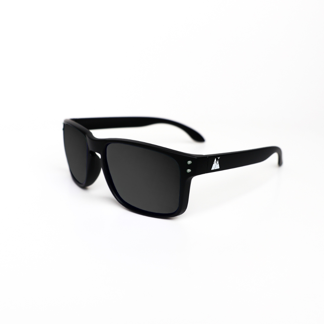 Black polarised sunglasses with a sleek matte finish, featuring a subtle mountain logo on the temple and dark tinted lenses, displayed against a clean white background.