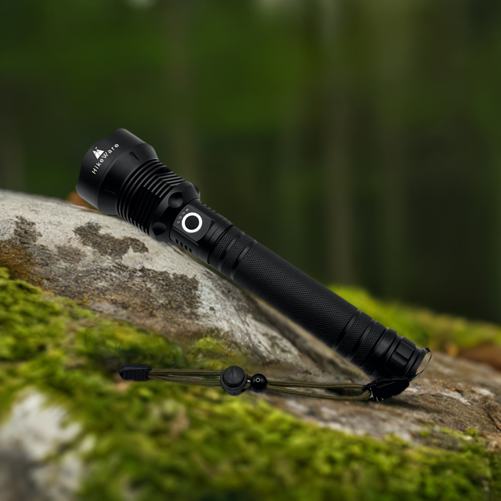 HikeWare LED flashlight resting on a mossy rock in woodland