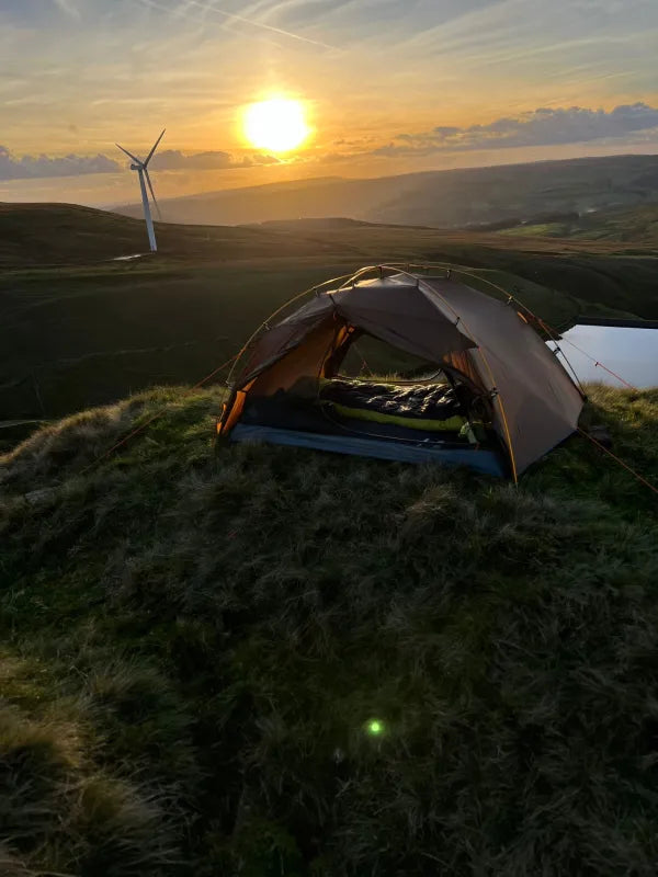 Night Cat 2 person tent in brown pitched on a moor at sunset
