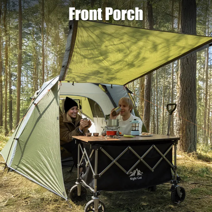 Campers at a table under the Night Cat pop-up cabin tent&