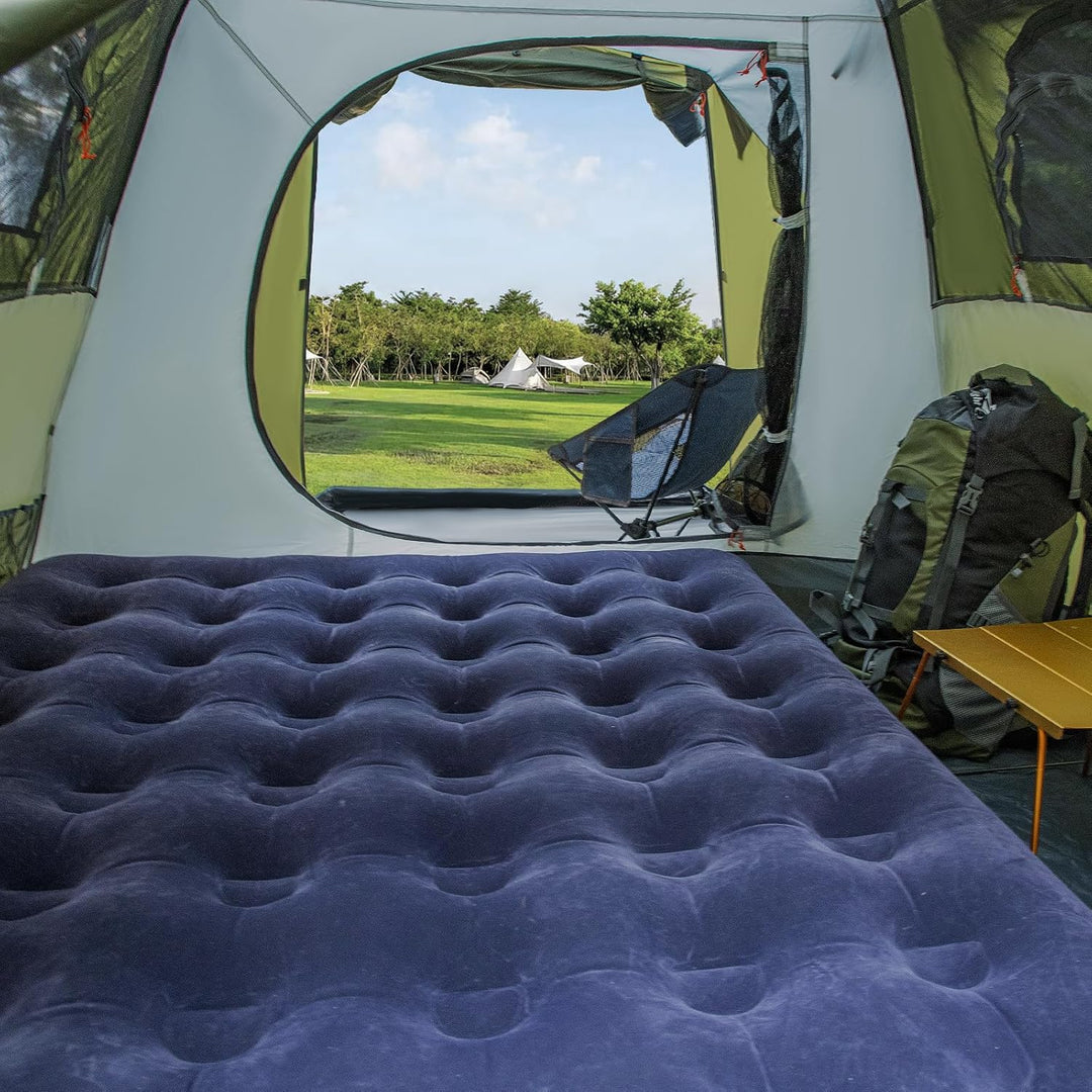 Inside the Night Cat pop-up cabin tent with a double air mattress and the door open