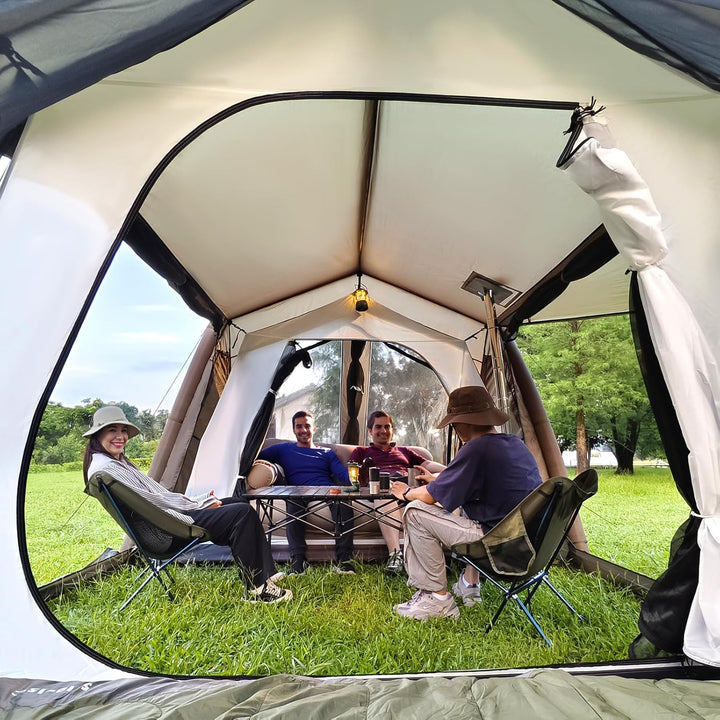 Group sitting inside the central living area of the Night Cat 8 person inflatable tent