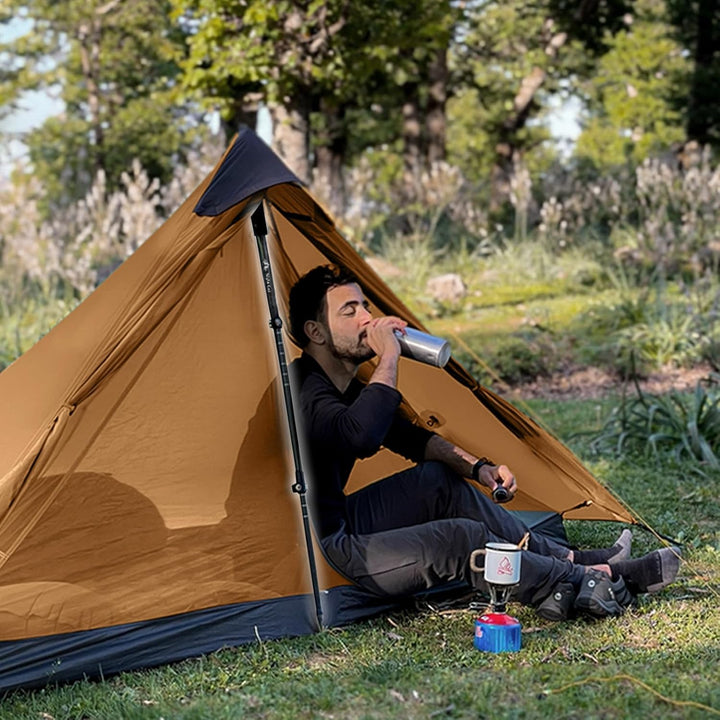 Night Cat trekking pole used to pitch a pyramid tent while a camper relaxes inside